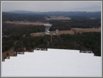 View of the NRAO 140 ft. radiotelescope from top of the receiver room of the GBT (2005).  Only a small part of the 100 m GBT dish is in view at the bottom half of photo (photo taken by Lovas).