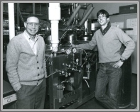 Alan Pine (left) and Jerry Fraser standing next to the microwave and infrared  electric-resonance optothermal (EROS) spectrometer about 1989.  This spectrometer was described in G.T. Fraser and A.S. Pine, J. Chem. Phys. 91, 637 (1989).