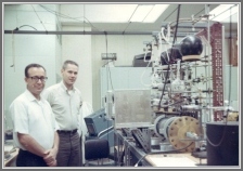 Francis X. Powell (right) and Don Johnson (left) in the new laboratory space at the Gaithersburg site, around 1969.  The parallel plate Stark cell is visible at bottom right, with sample handling glass vacuum line above it. The black unit at lower right is an oil bath can containing the klystron.