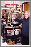 Compact version of the supersonic expansion FTMW spectrometer used for electric discharge and laser ablation studies.  H.Mäder is pointing out the laser input port.  The spectrometer is equipped with Helmholtz coils for cancelling the Earth magnetic field, which is mandatory in studies of paramagnetic molecules.