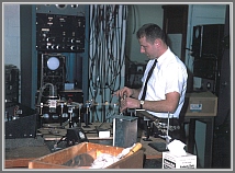 Gisbert Winnewisser making his first multiplier contact in the Gordy laboratory at Duke University (196?).  The procedure involved making a home-made diode at the contact between a sharpened tungsten whisker and a silicon crystal. The crystal was mounted on a differential screw mechanism and needed to be delicately brought to the whisker, while watching the oscilloscope display of the frequency-multiplied signal.